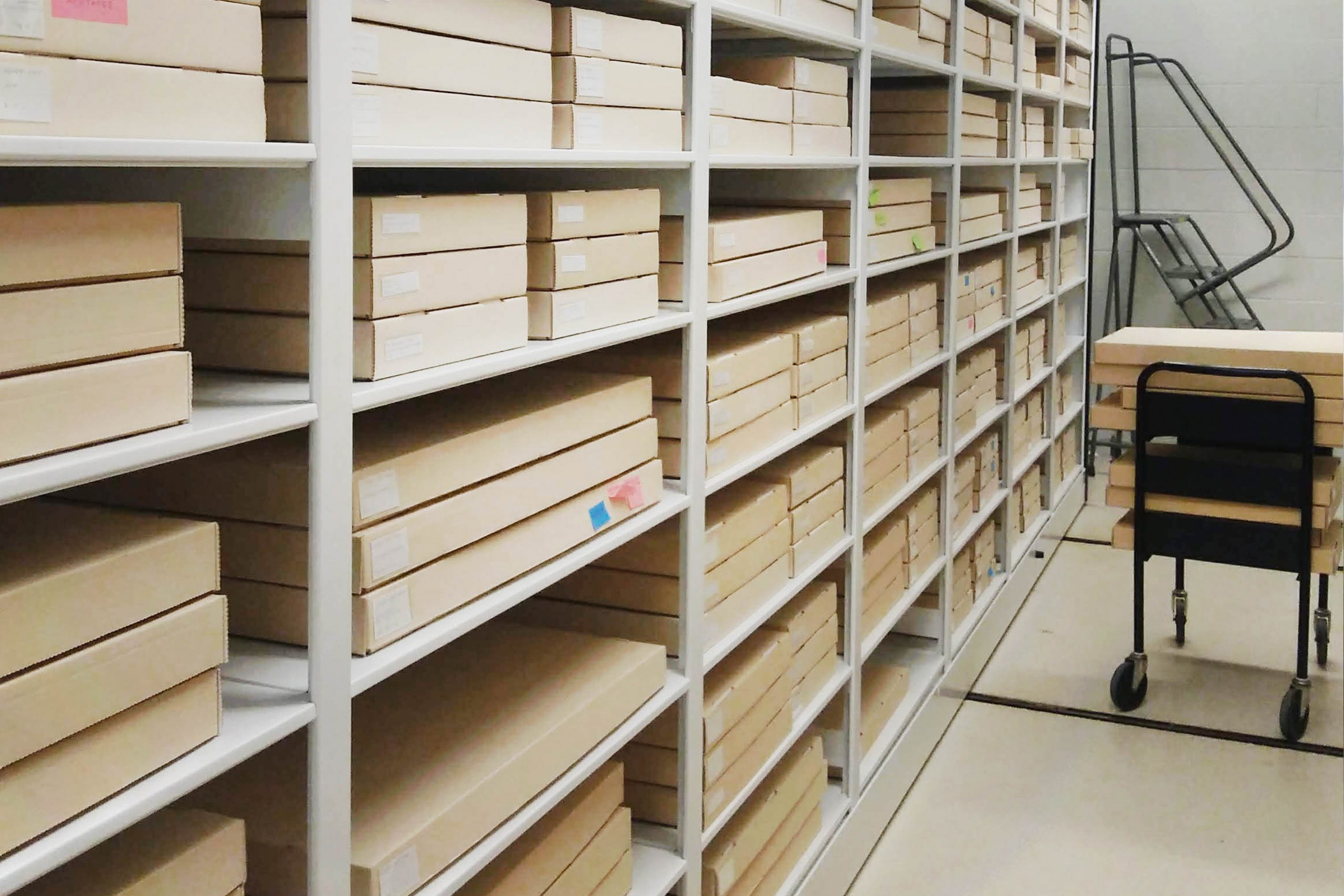 Photo of a computer, microphone, document scanner, camera, and touch screen device on the desk in the One Button Studio